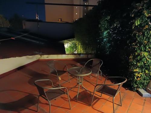 two chairs and a table on a patio at night at La Cara Oculta de Salta Bed and Breakfast in Salta