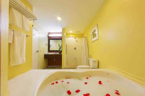 a bathroom with a tub with red hearts on it at Courtyard by Marriott Paramaribo in Paramaribo
