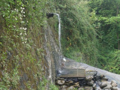 a waterfall on the side of a rock wall at B&B Scacco Matto in Popiglio
