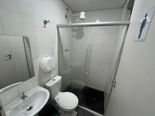 uma casa de banho com um chuveiro, um WC e um lavatório. em Hotel Barroco em Belo Horizonte