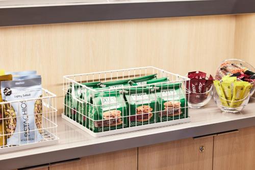 a shelf with a basket of food on a counter at AC Hotel by Marriott Sunnyvale Moffett Park in Sunnyvale