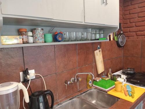 a kitchen with a sink and a counter top at La Casita de Mogotes in Mar del Plata