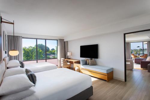 a hotel room with two beds and a television at Hotel Citrine, Palo Alto, a Tribute Portfolio Hotel in Palo Alto