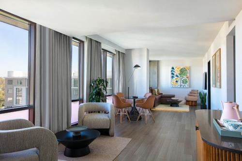 a living room with a couch and a table with chairs at Hotel Citrine, Palo Alto, a Tribute Portfolio Hotel in Palo Alto