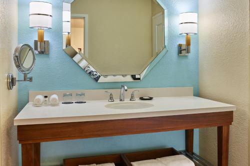 a bathroom with a sink and a mirror at Sheraton Orlando Lake Buena Vista Resort in Orlando