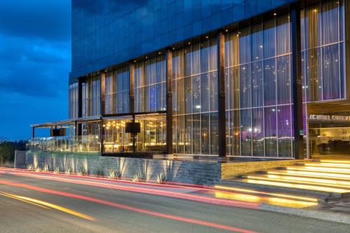 a building on the side of a street at night at AC Hotel Queretaro Antea in Querétaro