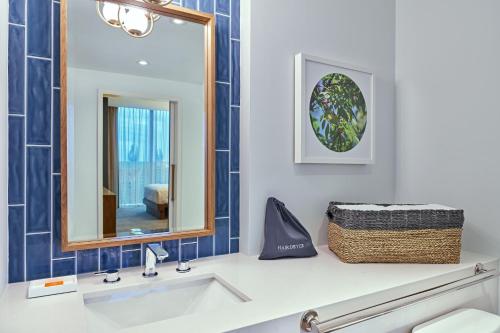 a bathroom with a sink and a mirror at Walt Disney World Swan Reserve in Orlando
