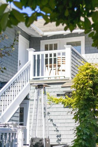 a white house with a porch with a deck at Shelburne Hotel in Seaview