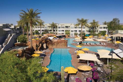 a swimming pool with umbrellas and a resort at Marriott's Canyon Villas in Phoenix