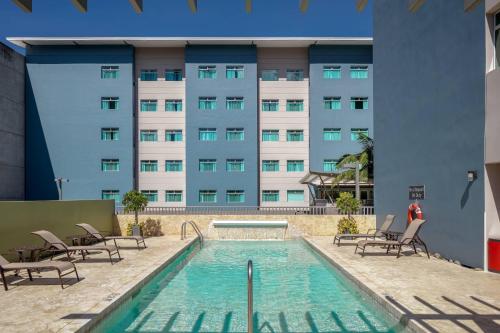 a swimming pool in front of a building at Residence Inn by Marriott San Jose Escazu in San José