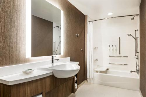 SpringHill Suites by Marriott Camp Hill في Camp Hill: حمام مع حوض ومرحاض وحوض استحمام