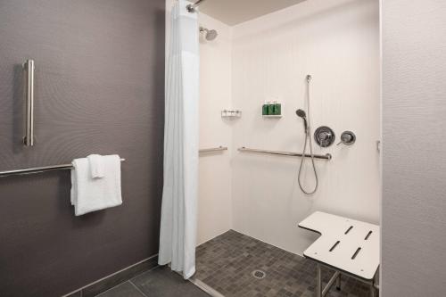 a bathroom with a shower and a sink at Courtyard Seattle Southcenter in Tukwila