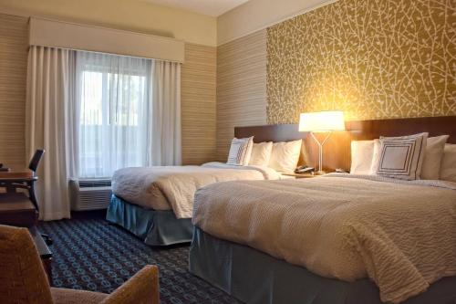 a hotel room with two beds and a window at Fairfield Inn & Suites by Marriott Reading Wyomissing in Wyomissing