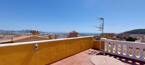 a balcony with a view of the city and the ocean at Villa Granada Motril in Motril