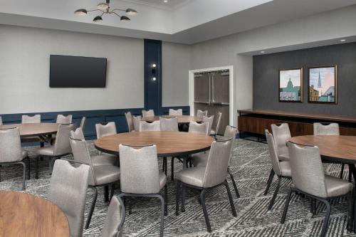 a conference room with tables and chairs and a tv at Courtyard by Marriott Savannah Downtown - Historic District in Savannah