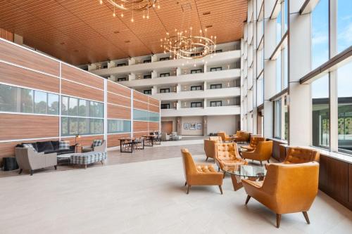 an office lobby with chairs and tables and windows at Four Points by Sheraton Spartanburg in Spartanburg