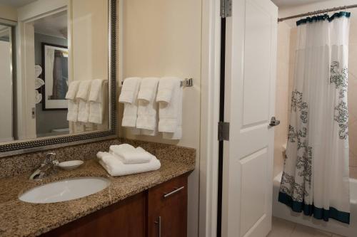 a bathroom with a sink and a mirror at Residence Inn Fort Myers Sanibel in Truckland