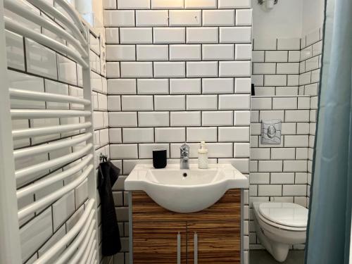 a white bathroom with a sink and a toilet at BEM by Small Home Budapest in Budapest