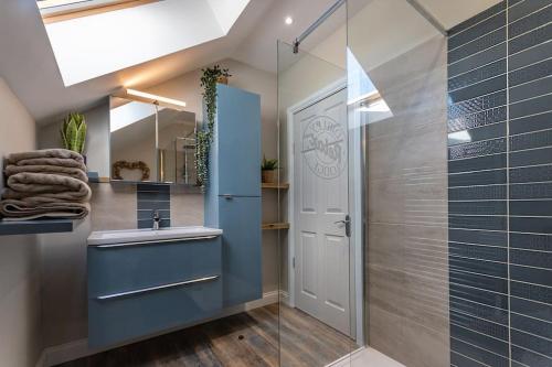 a bathroom with a shower and a sink and a mirror at Luxury retreat in Lincolnshire with hot tub in Cranwell