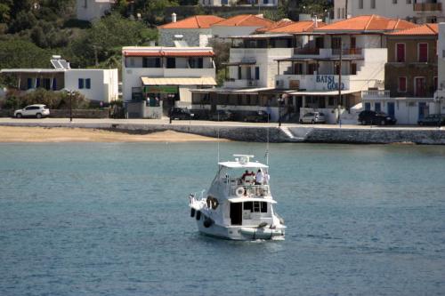 a small boat in the water near a city at Bella Vista in Batsi