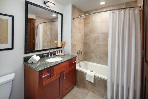 a bathroom with a sink and a tub and a shower at Marriott's Kauai Lagoons - Kalanipu'u in Lihue