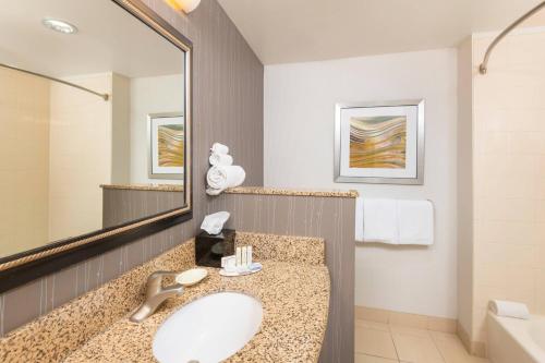 a bathroom with a sink and a mirror at Courtyard Phoenix North / Happy Valley in Phoenix