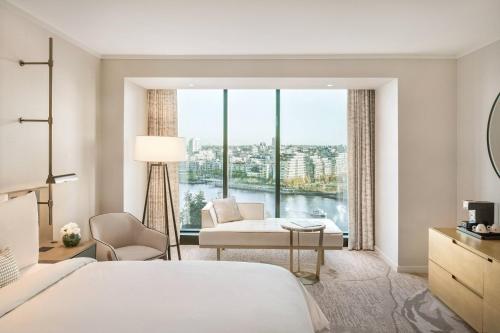 a hotel room with a bed and a large window at JW Marriott Parq Vancouver in Vancouver