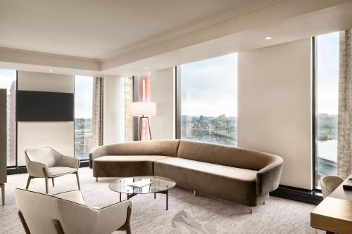 a living room with a couch and a large window at JW Marriott Parq Vancouver in Vancouver