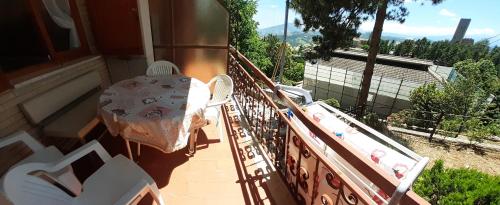 a balcony of a house with a table and chairs at Casetta Appennina (Bike Host) in Montefalcone Appennino