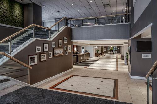 a lobby with a staircase and a stair case at Delta Hotels by Marriott Montreal in Montreal