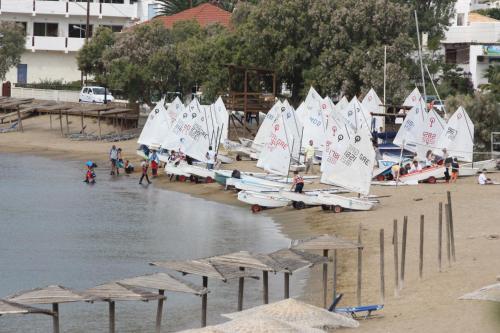 a bunch of sailboats on a beach with people on it at Bella Vista in Batsi