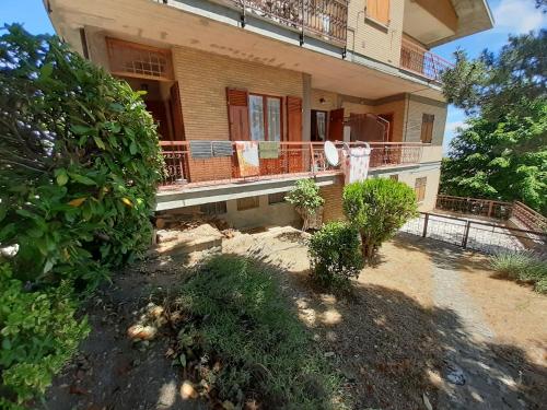 a large house with a porch and a balcony at Casetta Appennina (Bike Host) in Montefalcone Appennino
