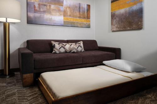 a living room with a couch and a bed at SpringHill Suites by Marriott Pittsburgh Mt. Lebanon in Mount Lebanon