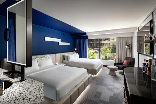 a hotel room with a bed and a blue wall at W Toronto in Toronto