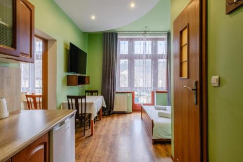 a room with a kitchen and a dining room at Apartamenty Krupówki in Zakopane