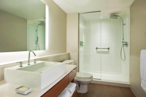 a bathroom with a sink and a shower and a toilet at Element Omaha Midtown Crossing in Omaha