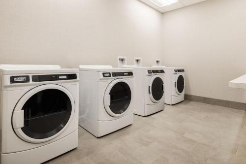 three washers and dryers in a laundry room at Element San Jose Airport in San Jose