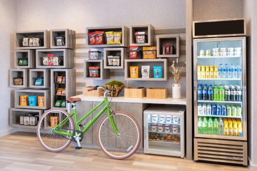 a bike parked in front of a drink refrigerator at Element San Jose Airport in San Jose