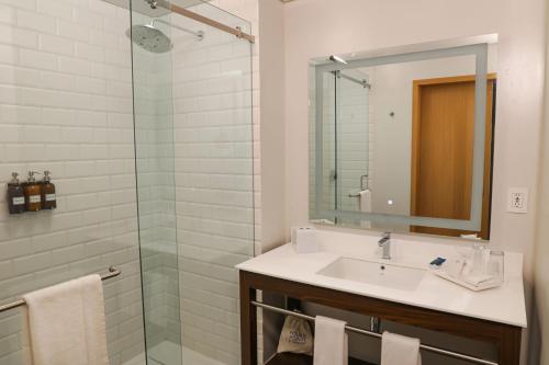 a bathroom with a sink and a glass shower at Four Points by Sheraton Mexico City Colonia Roma in Mexico City