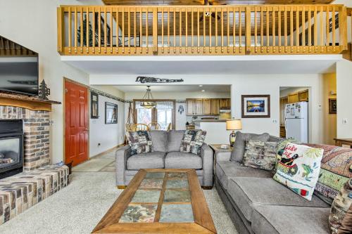a living room with a couch and a table at Fishing Haven Family Home on Indian Lake in Three Lakes
