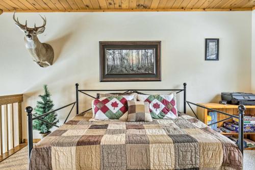 a bedroom with a bed and a deer head on the wall at Fishing Haven Family Home on Indian Lake in Three Lakes