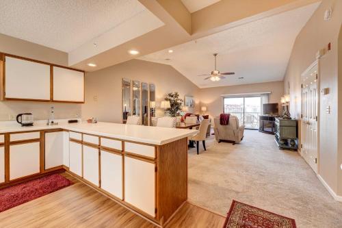 a kitchen with a counter and a living room at Branson Condo 1 Mi to Dolly Partons Stampede! in Branson