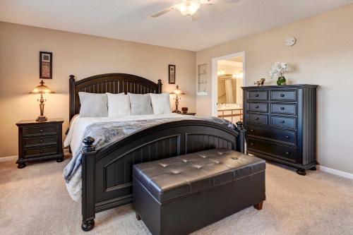 a bedroom with a bed and a dresser and a stool at Branson Condo 1 Mi to Dolly Partons Stampede! in Branson