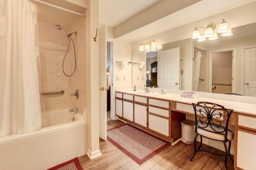 a bathroom with a tub and a sink and a shower at Branson Condo 1 Mi to Dolly Partons Stampede! in Branson