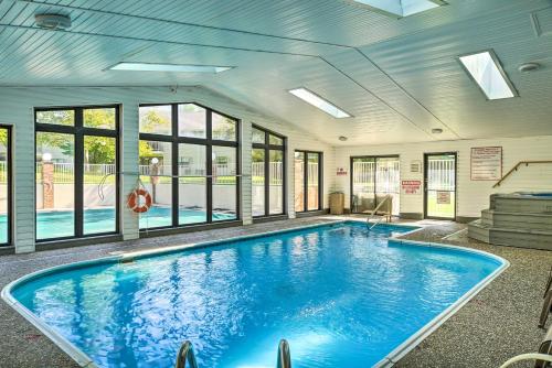 a swimming pool in a building with windows at Branson Condo 1 Mi to Dolly Partons Stampede! in Branson