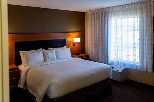 a hotel room with a large bed and a window at TownePlace Suites by Marriott Lancaster in Lancaster