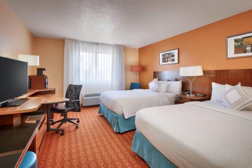 a hotel room with two beds and a desk and a television at Fairfield Inn by Marriott Provo in Provo