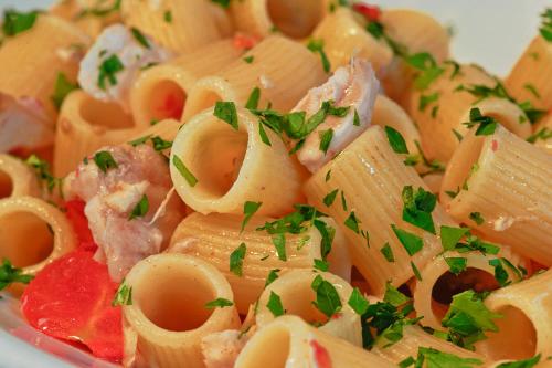 a plate of pasta with meat and parsley on it at Hotel Villa Mena in Ischia