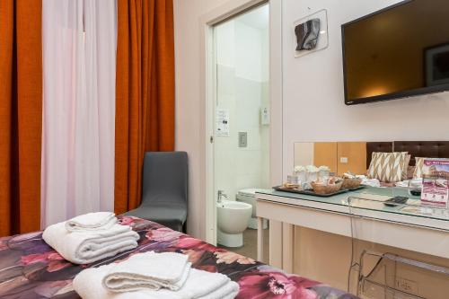 a room with a bed and a bathroom with a mirror at St. Peter's Relax in Rome