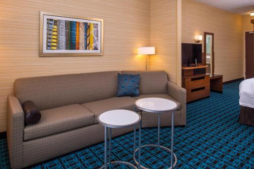 a living room with a couch and two tables at Fairfield Inn & Suites by Marriott St. Louis Westport in Maryland Heights